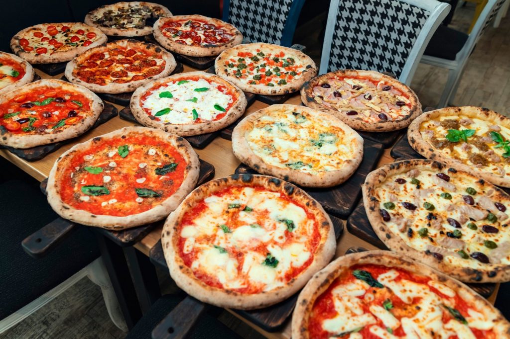 selection of pizzas inside pizza shop
